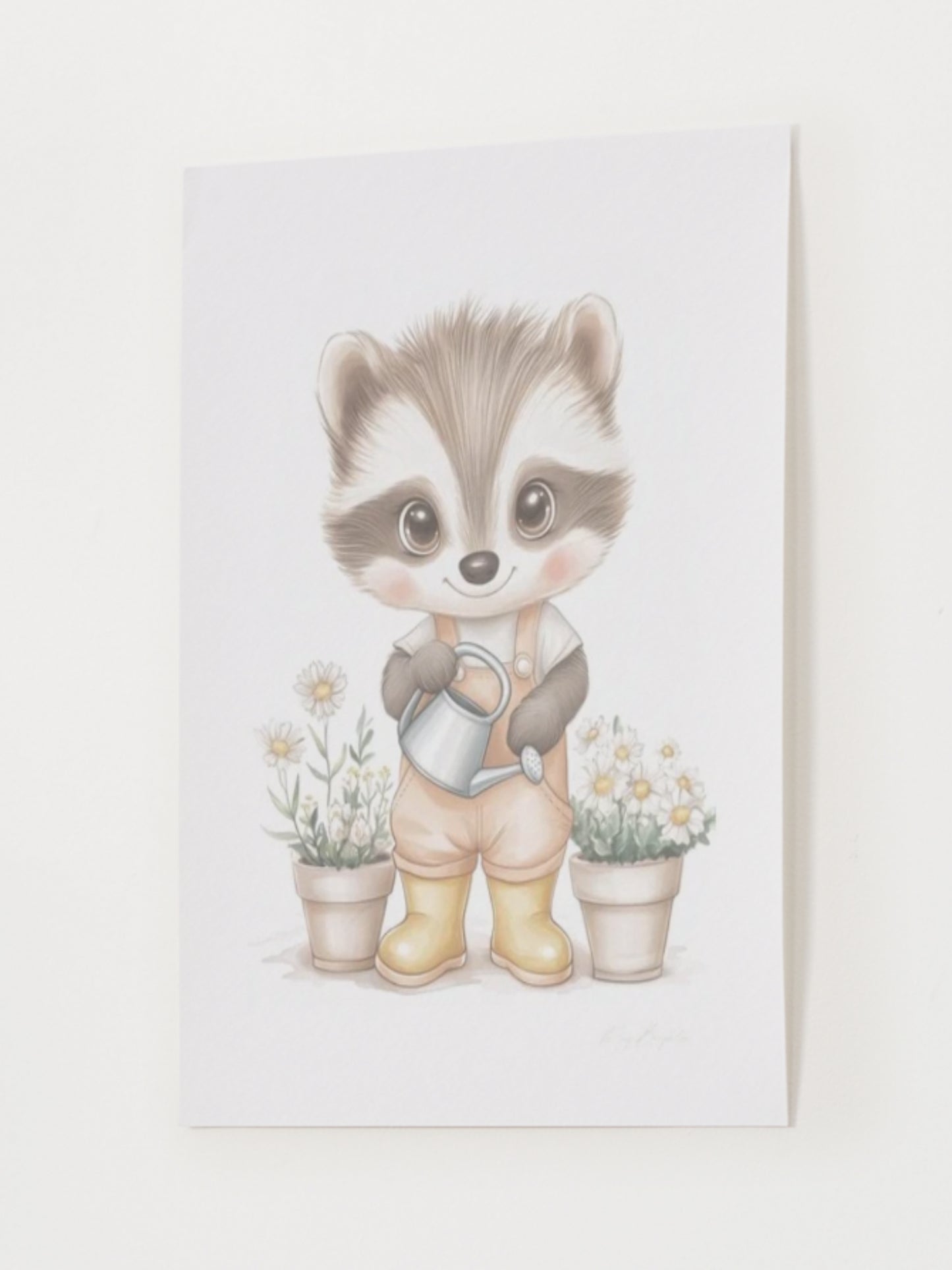 Watercolor-style nursery art print of Elliot, a gentle raccoon wearing yellow boots and holding a watering can. Surrounded by soft garden details. Part of The Littlest Collection by Little Snuggle Studio.