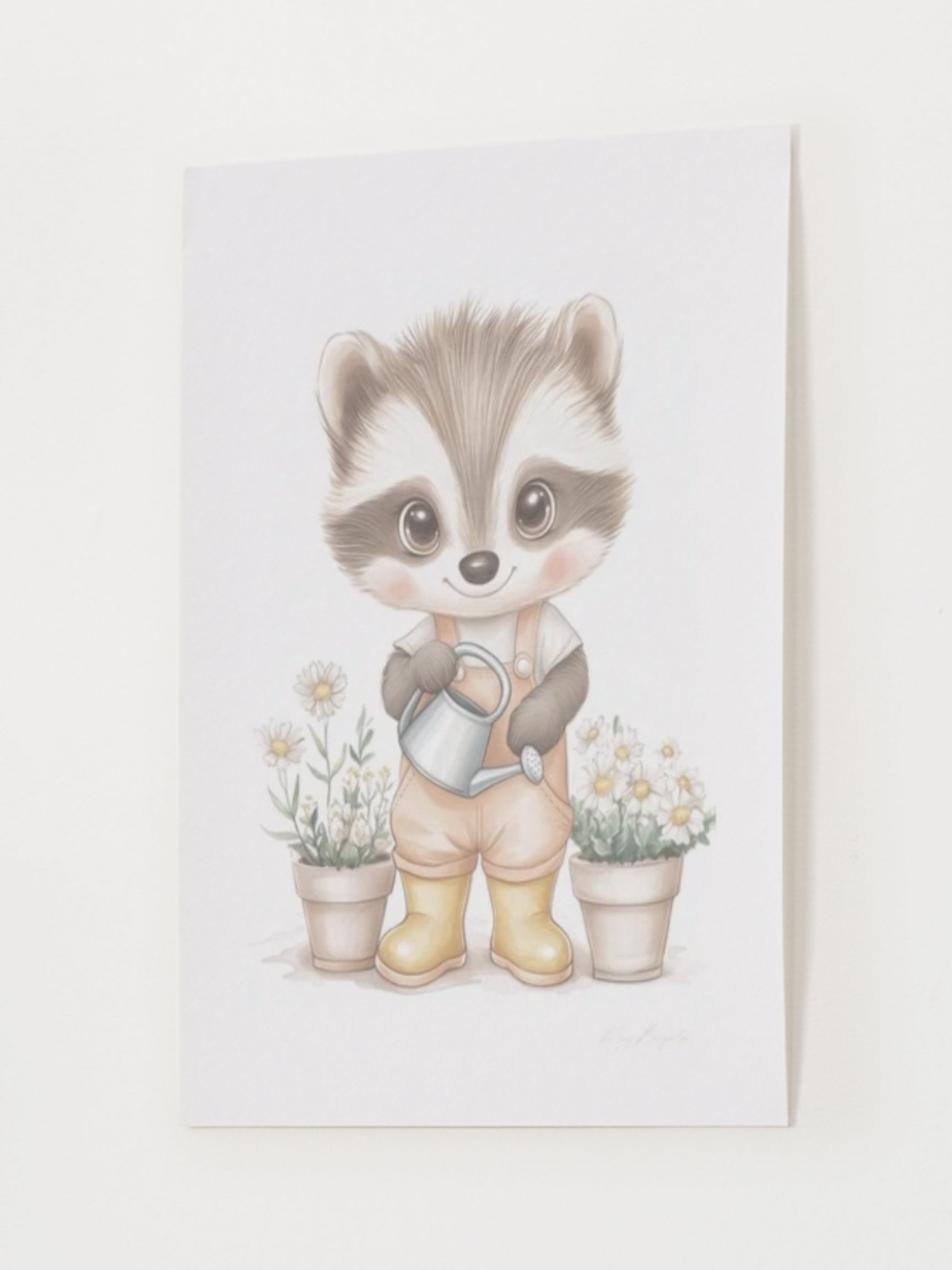 Watercolor-style nursery art print of Elliot, a gentle raccoon wearing yellow boots and holding a watering can. Surrounded by soft garden details. Part of The Littlest Collection by Little Snuggle Studio.